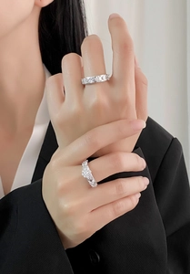 Detail of S925 sterling silver leaf ring set with sparkling zircons on model hand