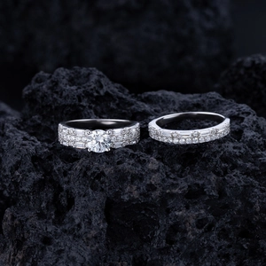 Macro detail of 925 silver wedding ring set with sparkling zircon on black rock