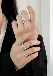 Close-up of elegant silver eternity rings with square-cut diamonds on a model's hand