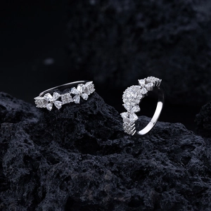 Sparkling S925 sterling silver floral rings with cubic zirconia on black volcanic stone