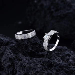 Macro detail of S925 sterling silver rings with emerald cut diamonds on volcanic stone