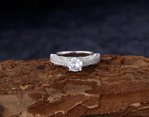 Macro shot of S925 sterling silver ring with large round solitaire on rustic bark