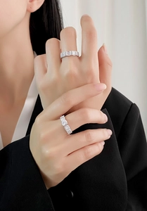Detailed close-up of s925 silver rings with square cut diamonds worn on a model hand
