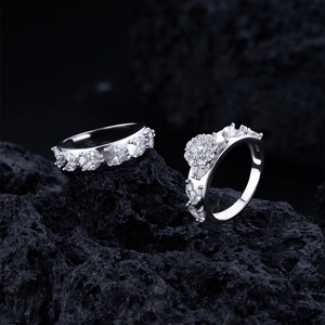 Elegant S925 sterling silver rings with leaf and flower diamond accents on black rock