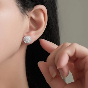 Close-up of S925 sterling silver pave setting round stud earrings on model's ear