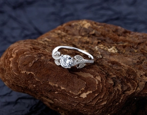 Macro view of a 925 silver leaf ring with a large zircon center stone and micro-pave details