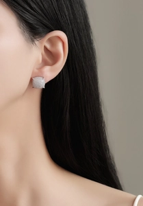 Close-up of luxury S925 sterling silver square stud earrings with pave set zircon on ear