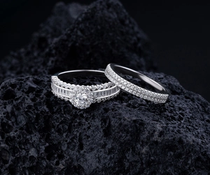Macro detail of silver halo ring set with micro-pave diamonds on dark volcanic rock