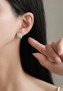 Detail of square cushion S925 silver stud earrings with micro-set zircons on ear