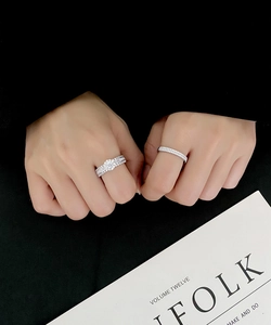 Macro view of stacked S925 silver rings with micro-pave diamonds on a model's finger