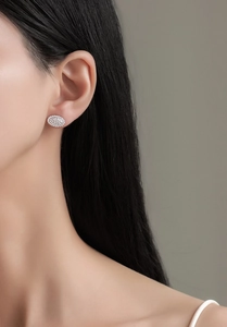 Macro detail of elegant oval micro-pave cubic zirconia stud earrings in sterling silver