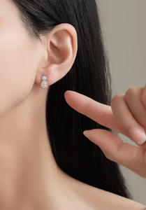 Close-up of S925 sterling silver wulu stud earrings with full micro-pave crystals on model