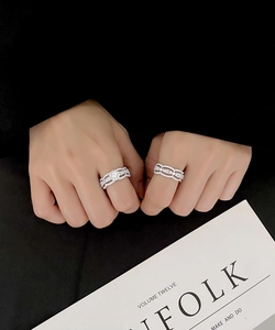 Detailed shot of wave-style S925 silver rings with micro-pave cubic zirconia crystals