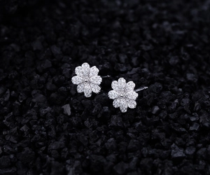 Macro shot of S925 sterling silver daisy earrings with micro-pave cubic zirconia