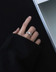Detail of s925 silver leaf ring with round zircon diamond worn on model's hand