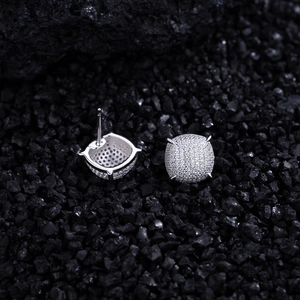 Macro shot of silver geometric square stud earrings with micro-paved sparkling cubic zirconia