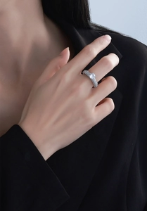 Close-up of S925 silver ring featuring a 2ct round diamond on a model in a black suit