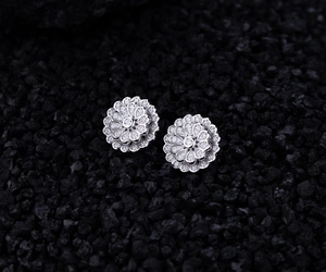 Macro detail of S925 silver double flower earrings with pavé zircon on black mineral stones