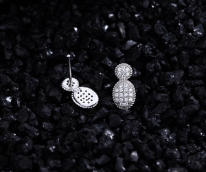 Macro view of S925 sterling silver oval stud earrings with pavé crystals and hallmark