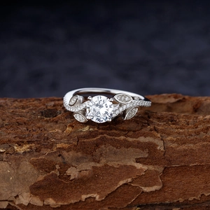 Leaf design S925 sterling silver ring with cubic zirconia on textured bark background