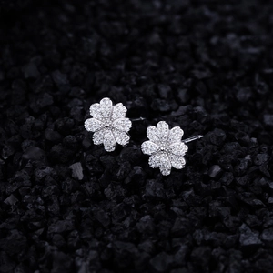 Sparkling S925 sterling silver daisy stud earrings with micro-paved zircons on black stone