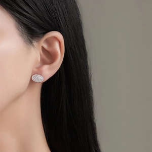 Elegant S925 sterling silver oval stud earrings with pavé cubic zirconia on model
