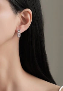 Close-up of S925 silver chain hoop earrings with micro-set zircons on a model