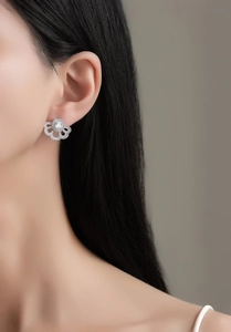 Macro view of sterling silver fan-shaped flower stud earrings with micro-set zircon accents