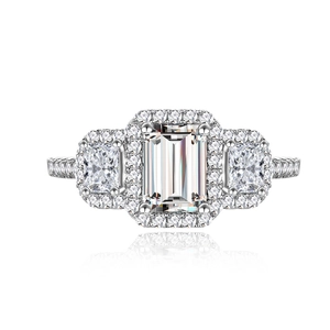 Elegant emerald cut three-stone ring with halo setting and micro-pave diamond band
