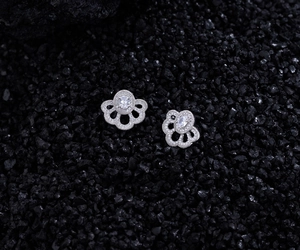 Macro detail of S925 silver fan-shaped earring with micro-set zircon and floral texture
