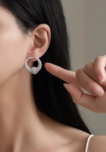 Close-up of S925 silver U-shaped hoop earrings with sparkling pave zircon on model