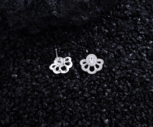Macro detail of S925 sterling silver fan-shaped stud earrings with micro-set zircon stones
