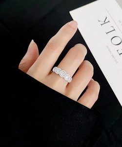 Detailed view of S925 silver ring featuring five halo-set round sparkling cubic zirconia