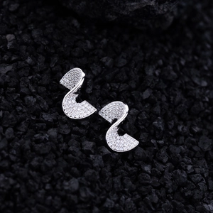 Elegant S-curve silver earrings with micro-pave cubic zirconia on black volcanic rock