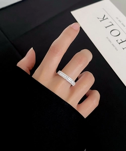 Detail of a silver S925 sterling silver ring with double row of 5A cubic zirconia on finger