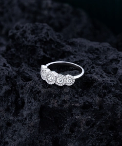 Macro view of S925 sterling silver ring with pavé round moissanite on black volcanic rock
