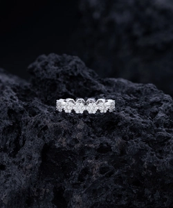 Macro shot of S925 sterling silver daisy ring with micro-pave crystals on black rock