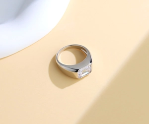 Detail of emerald cut rectangle zircon on polished sterling silver wide band ring