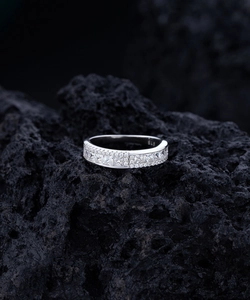 Close-up of S925 hallmark on a double-row silver ring with square zircon stones
