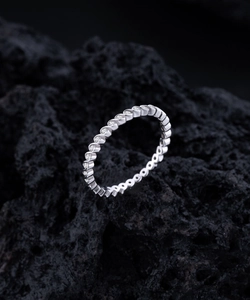 Macro detail of S925 sterling silver wavy ring with pave set sparkling diamonds