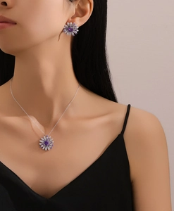 Detail of S925 silver necklace and earrings set with purple daisy floral pendants