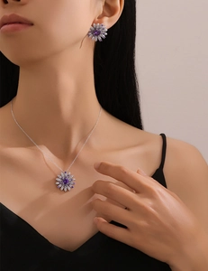 Close-up of S925 silver daisy jewelry set with purple crystals on a model