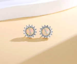 Macro shot of 925 silver sunflower stud earrings with natural opal and white zircon