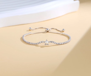 Close-up of S925 silver star bracelet with micro-paved diamonds and white pearl detail