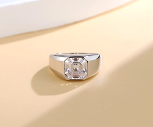 Macro shot of silver ring featuring a large square step-cut zircon on a wide band