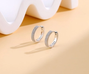 Detail view of S925 sterling silver huggie earrings with triple-row pavé zircon settings