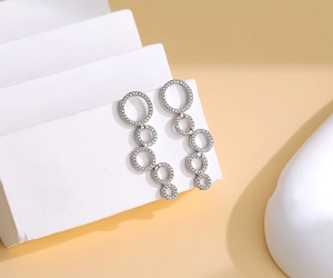 Detail of silver drop earrings with five cascading pavé rhinestone encrusted hoops