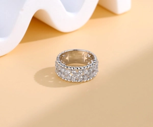 Macro shot of 925 silver four-leaf clover ring with pave-set white gems and bead edge