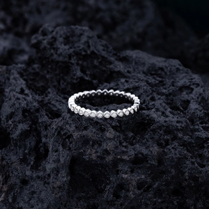 S925 sterling silver wave ring with pavé diamonds on textured black volcanic rock