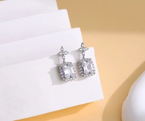 Detail of S925 sterling silver drop earrings with emerald-cut crystals and halo diamonds